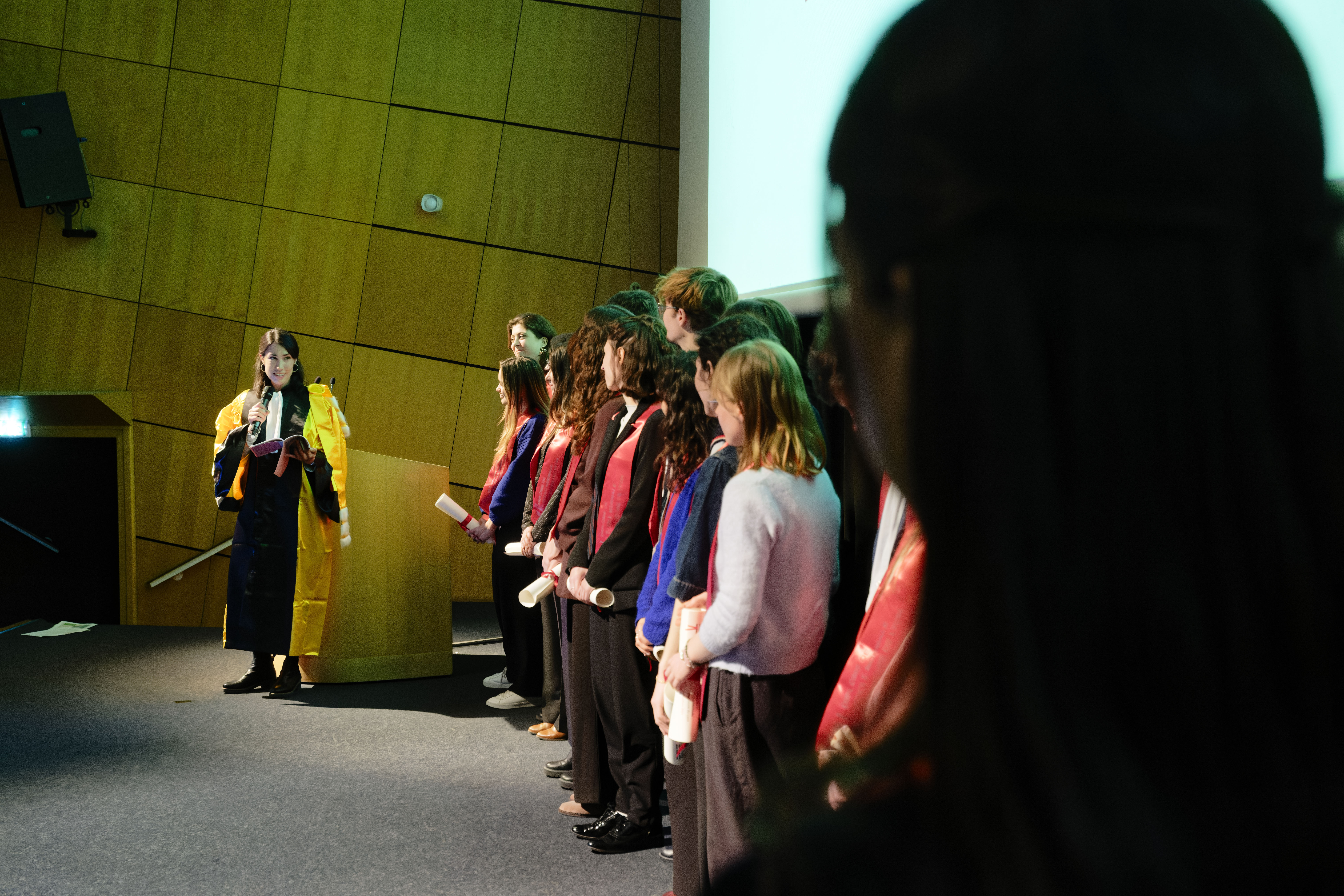 Graduates on the scene; the head of the department is giving a speech
