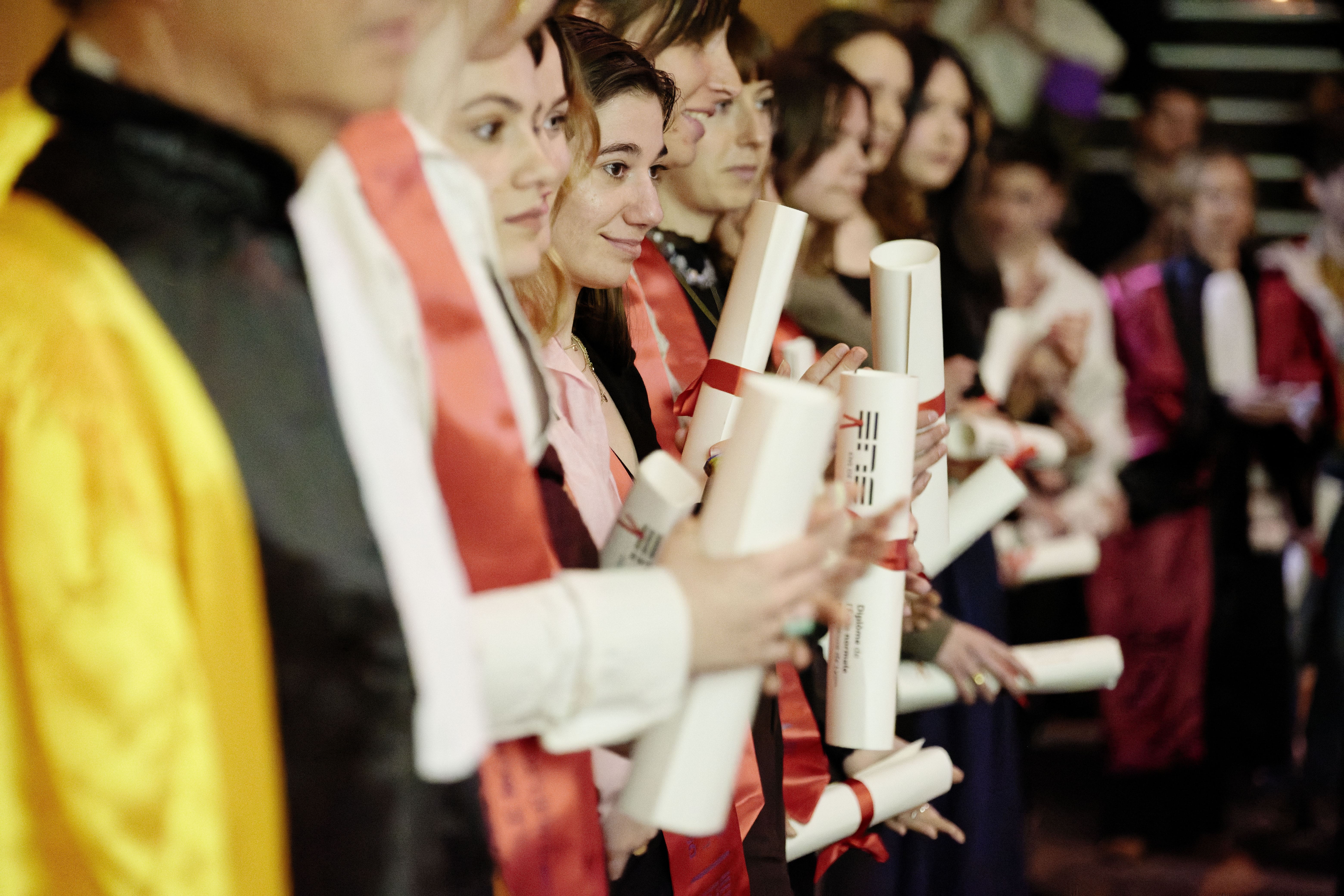 The graduates holding diplomas